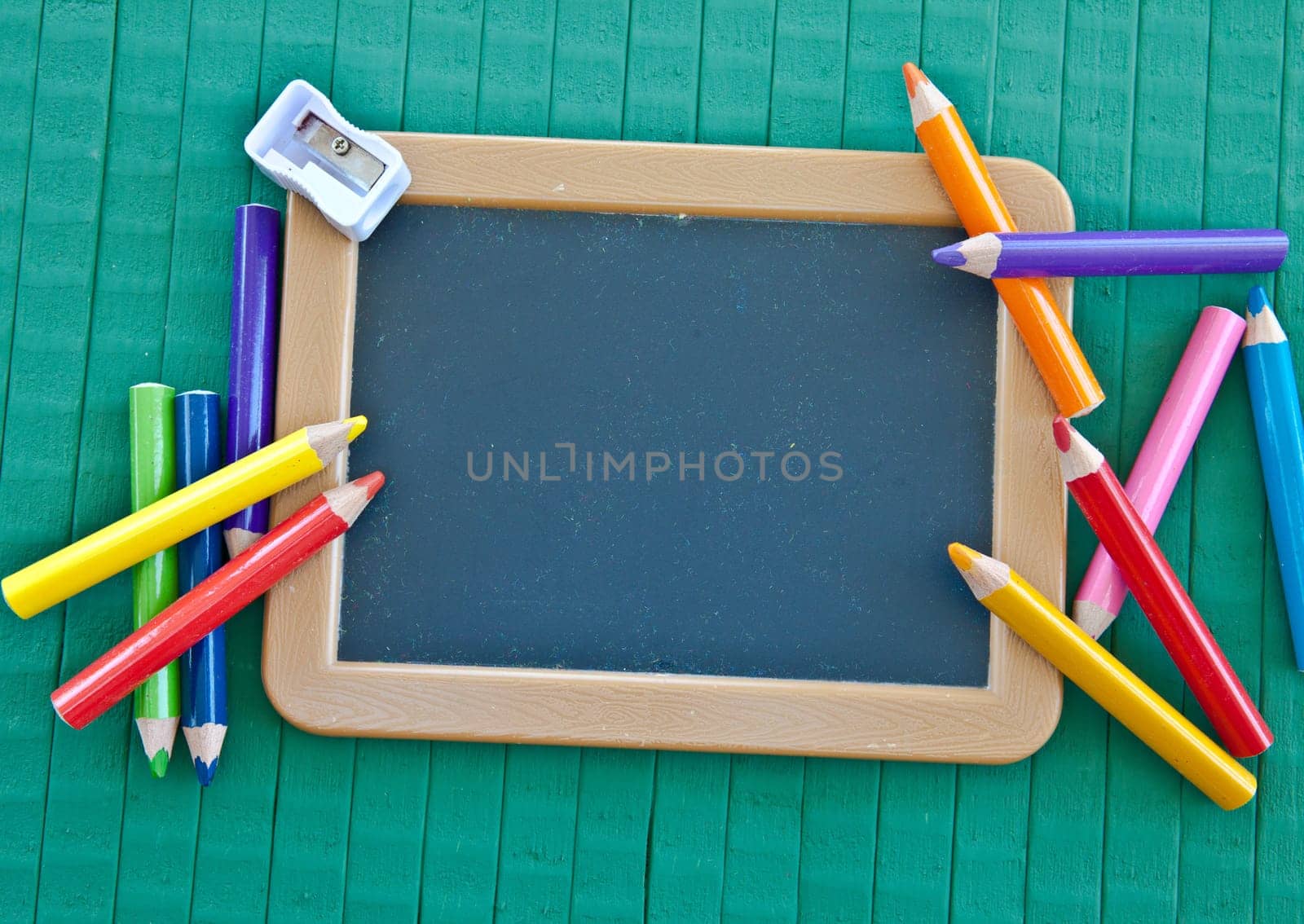 Back to school background with blackboard and coloured pencils