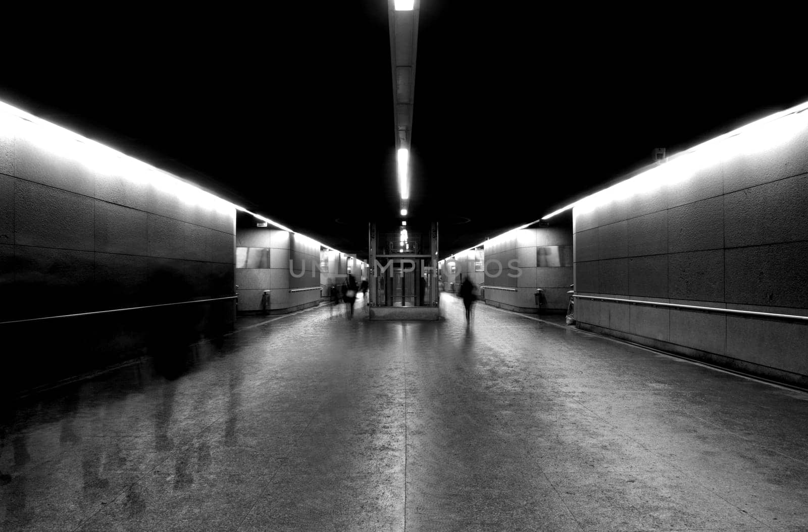motion blur of people walking in a underground tunnel