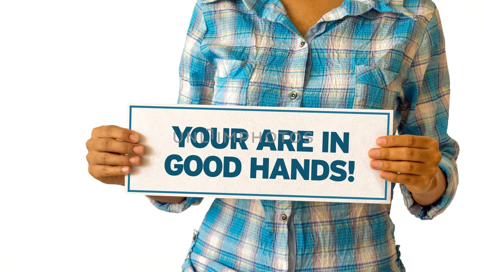 A woman holding a You are in Good hands sign.
