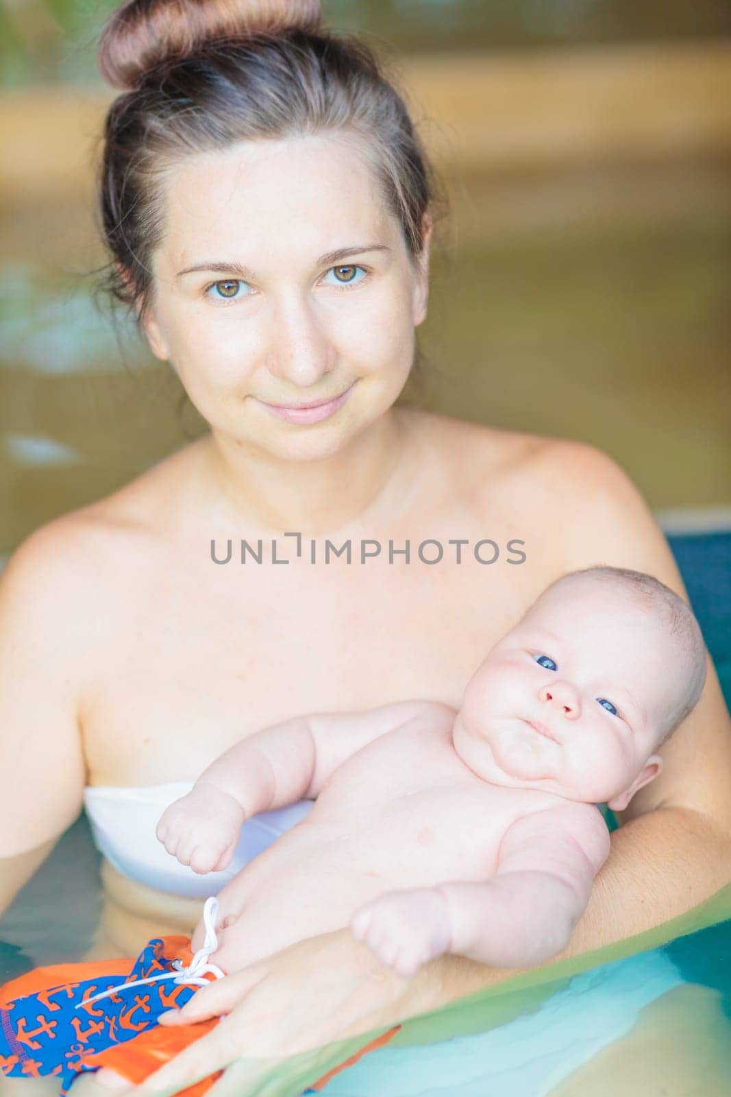 Baby and mom in swimming pool