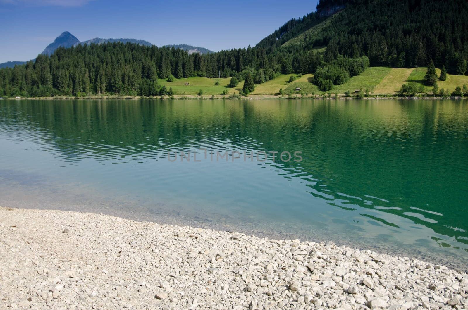 Stones on the lake in Tyrol with turquoise water