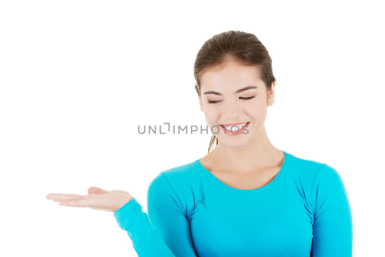happy,excited young woman presenting copy space on her palm,isolated on white