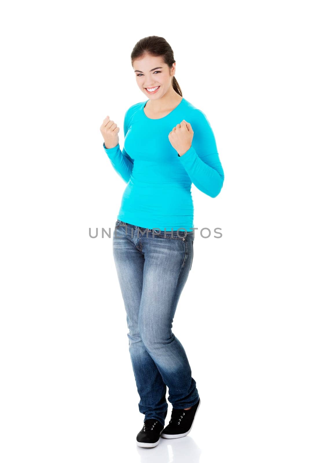 success excited happy young woman with fists up,isolated on white