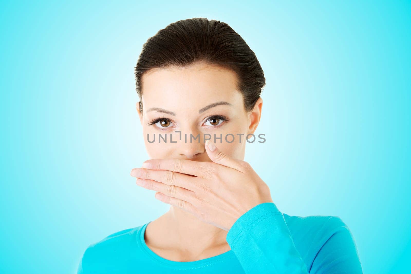 Woman covering mouth with hand
