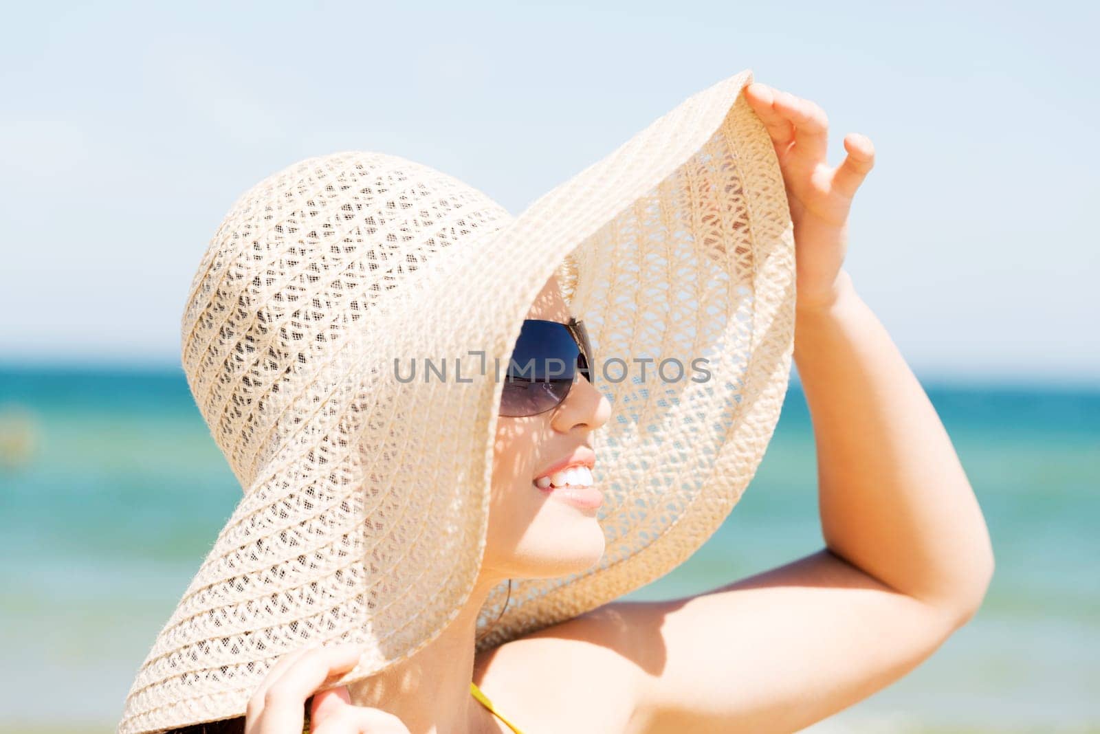 beautiful woman on a beach. coastline in sunglasses.