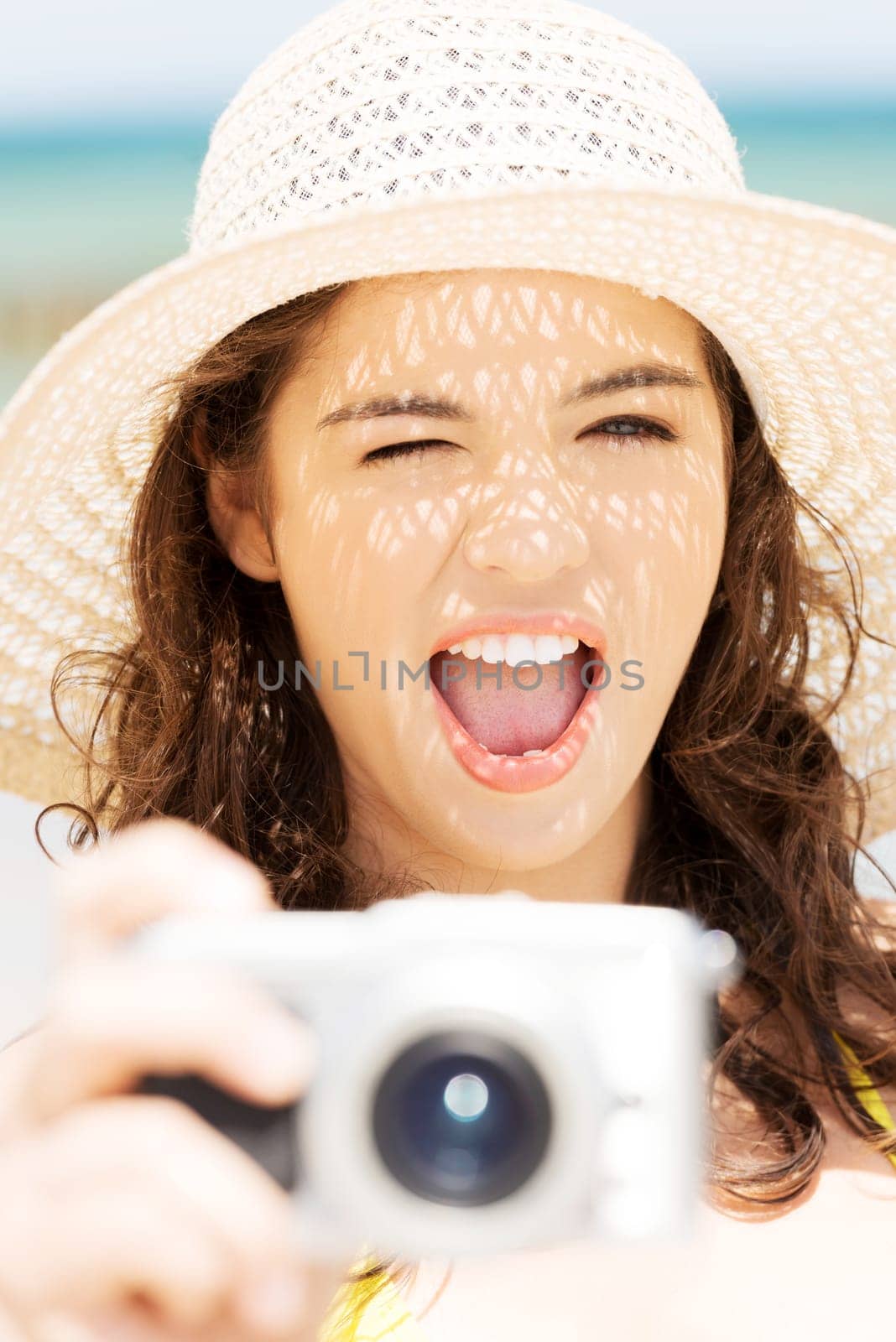 Attractive cheerful summer woman talking pictures with digital camera.