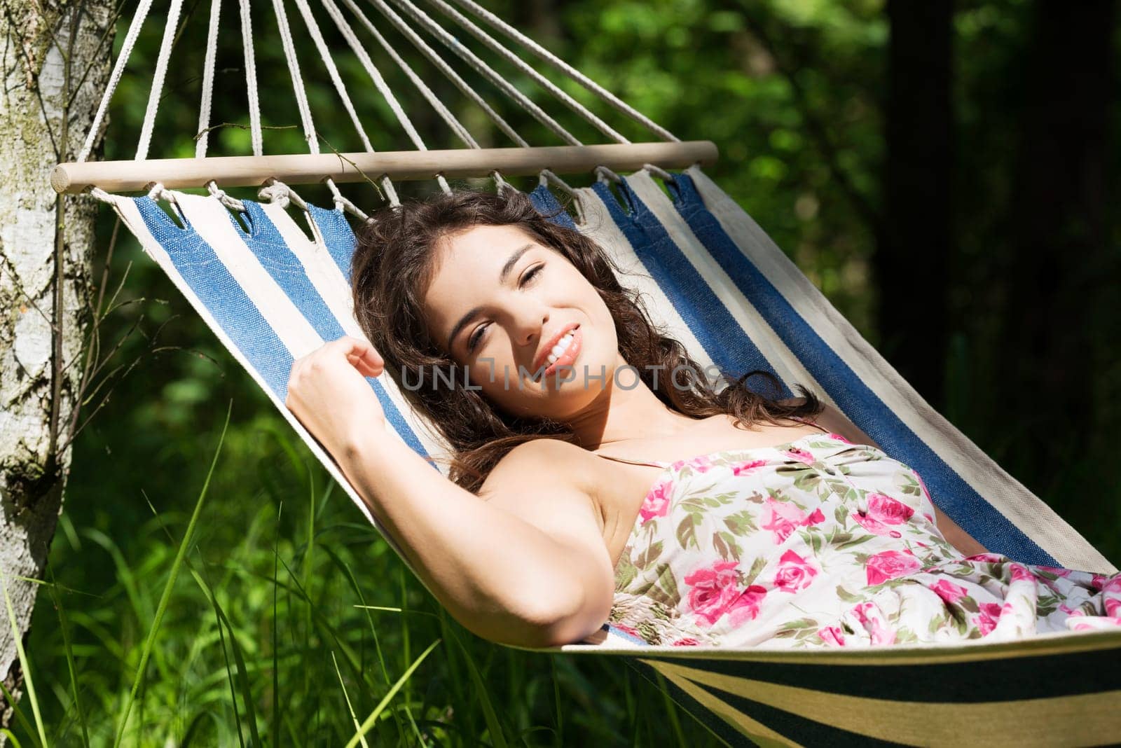 young woman lying in a hammock in the garden
