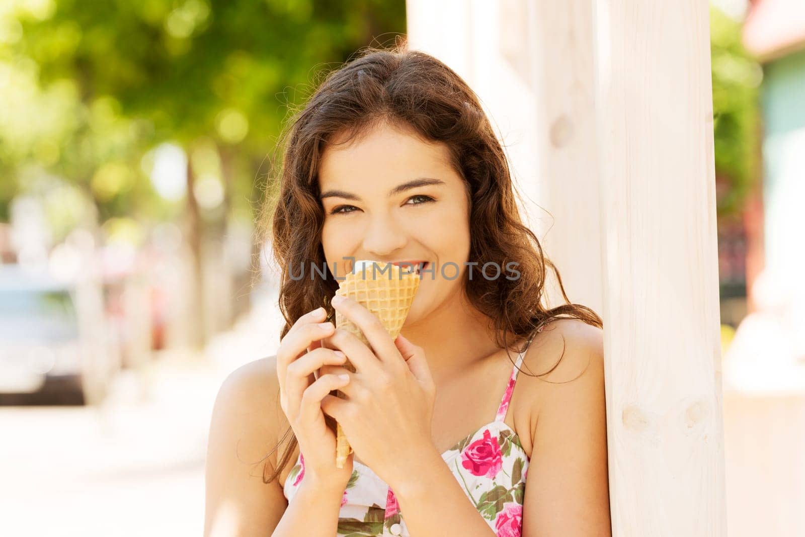portrait of young happy woman eating ice-cream,outdoor