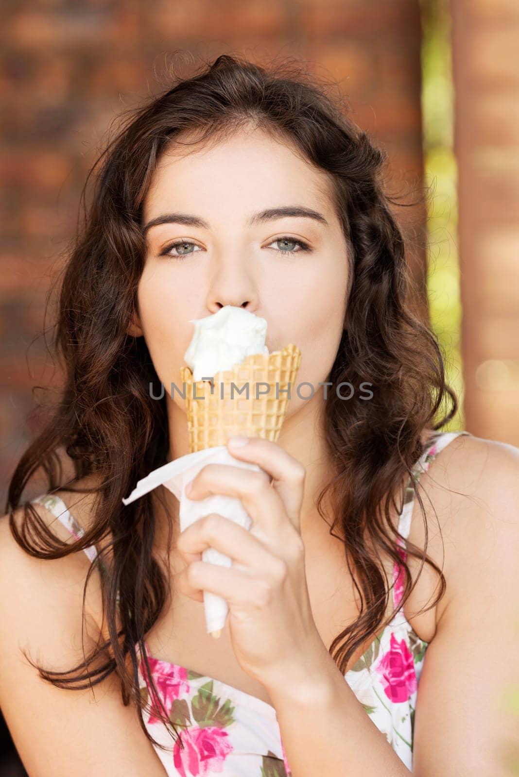 portrait of young happy woman eating ice-cream,outdoor