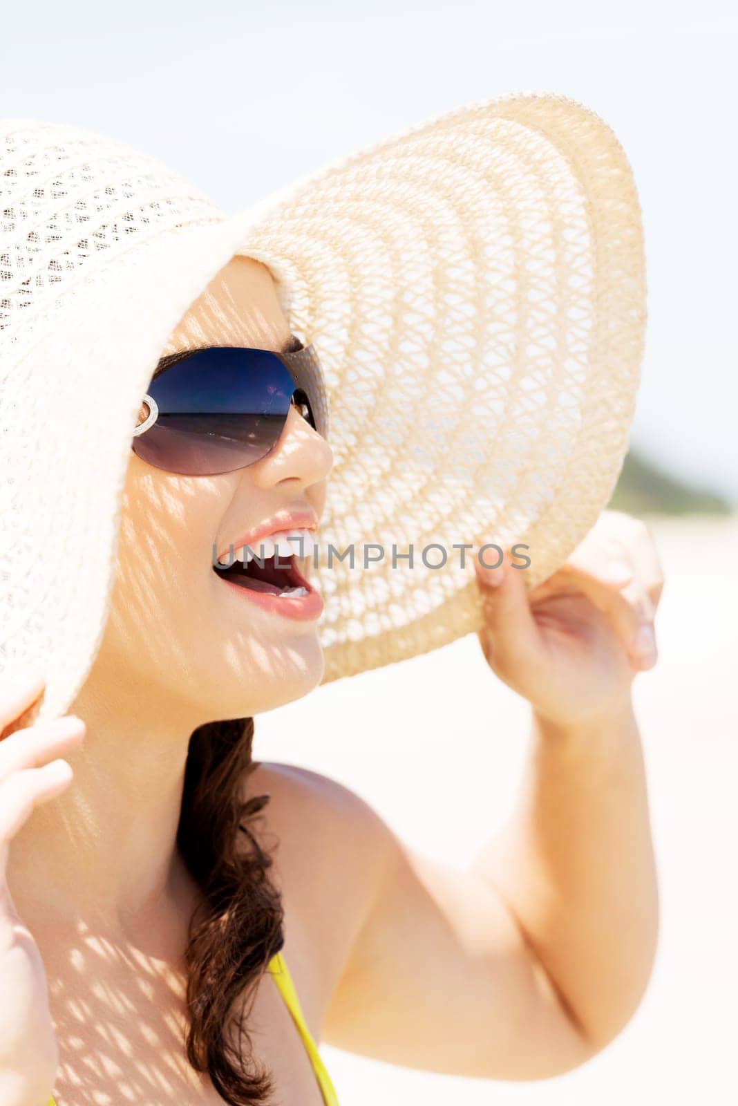 beautiful woman on a beach. coastline in sunglasses.
