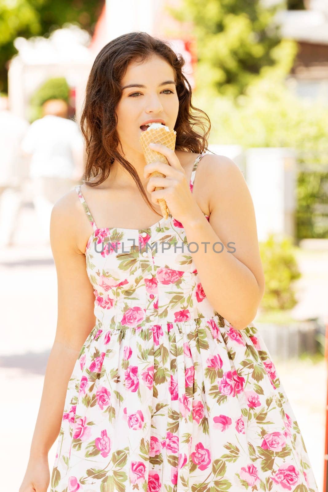 Portrait of young happy woman eating ice-cream,outdoor