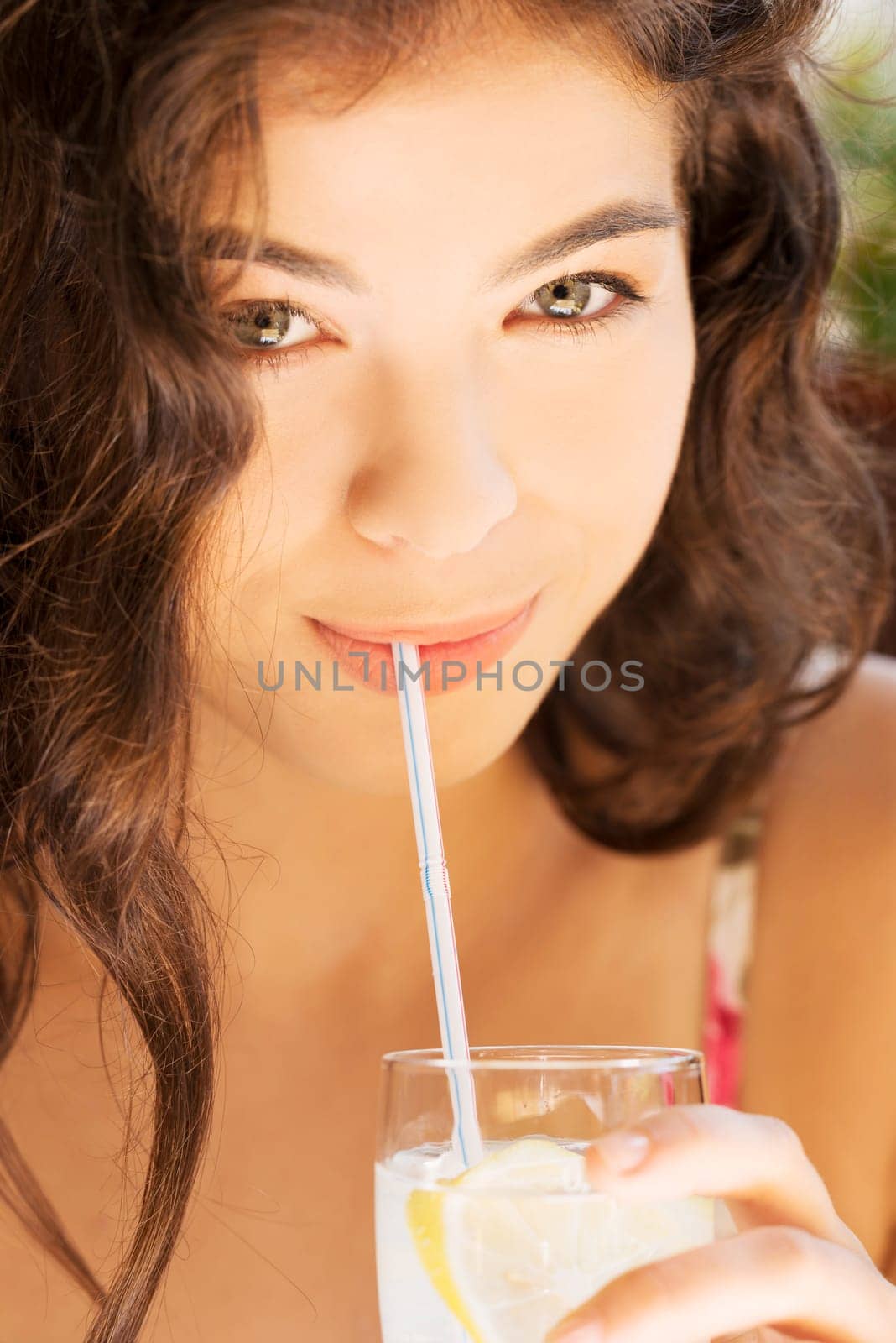 beautiful girl with drink or water in cafe