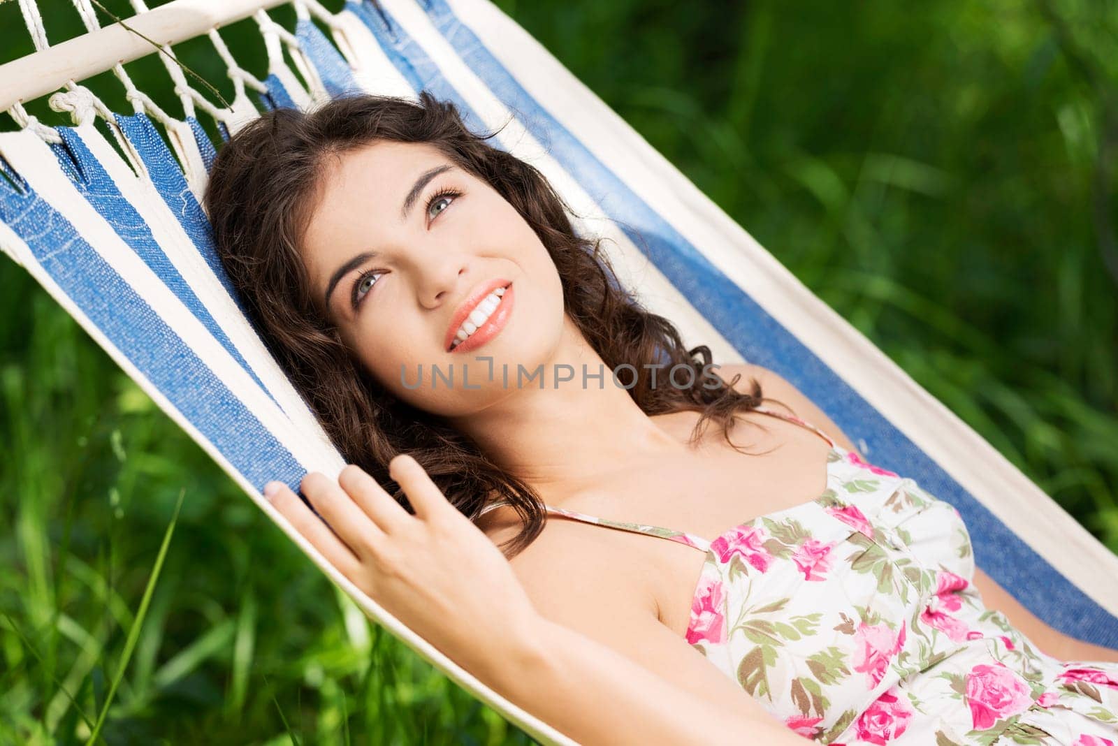 young woman lying in a hammock in the garden