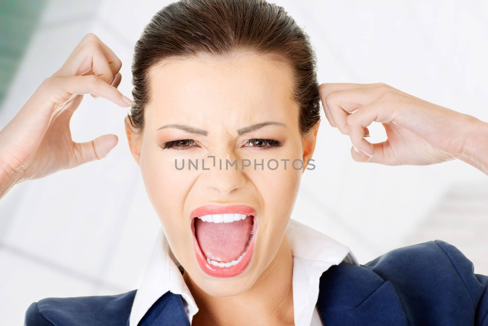 Stressed or angry businesswoman screaming loud
