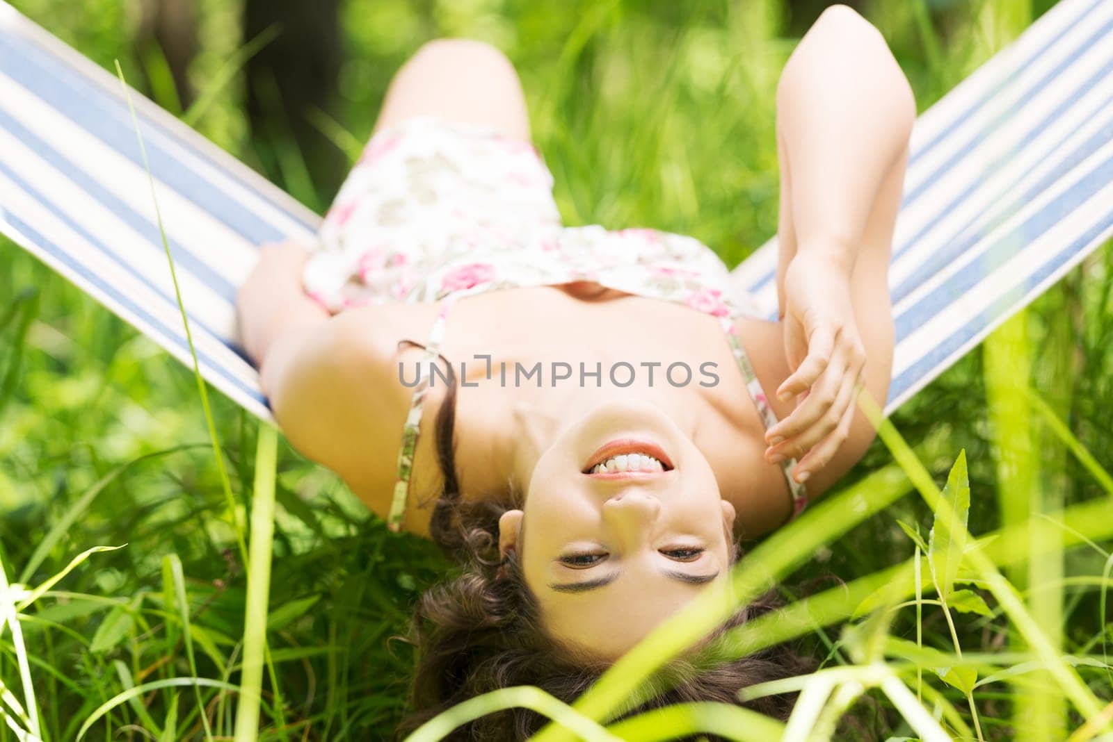 young woman lying in a hammock in garden