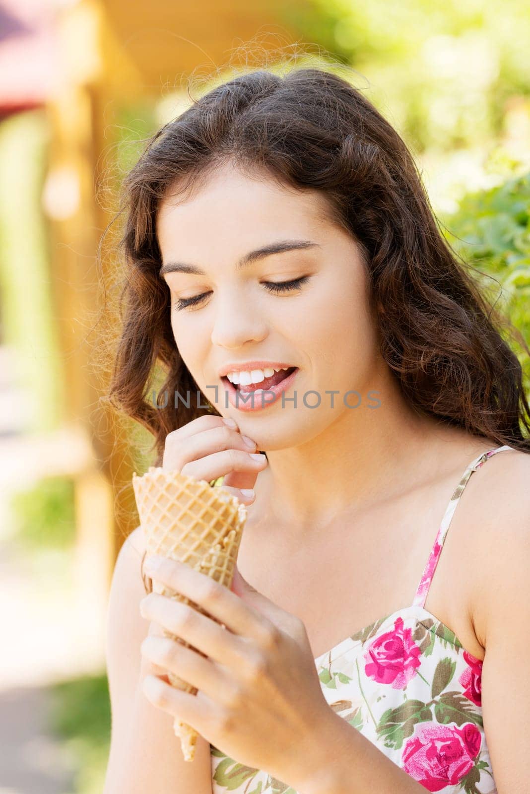 Portrait of young happy woman eating ice-cream,outdoor