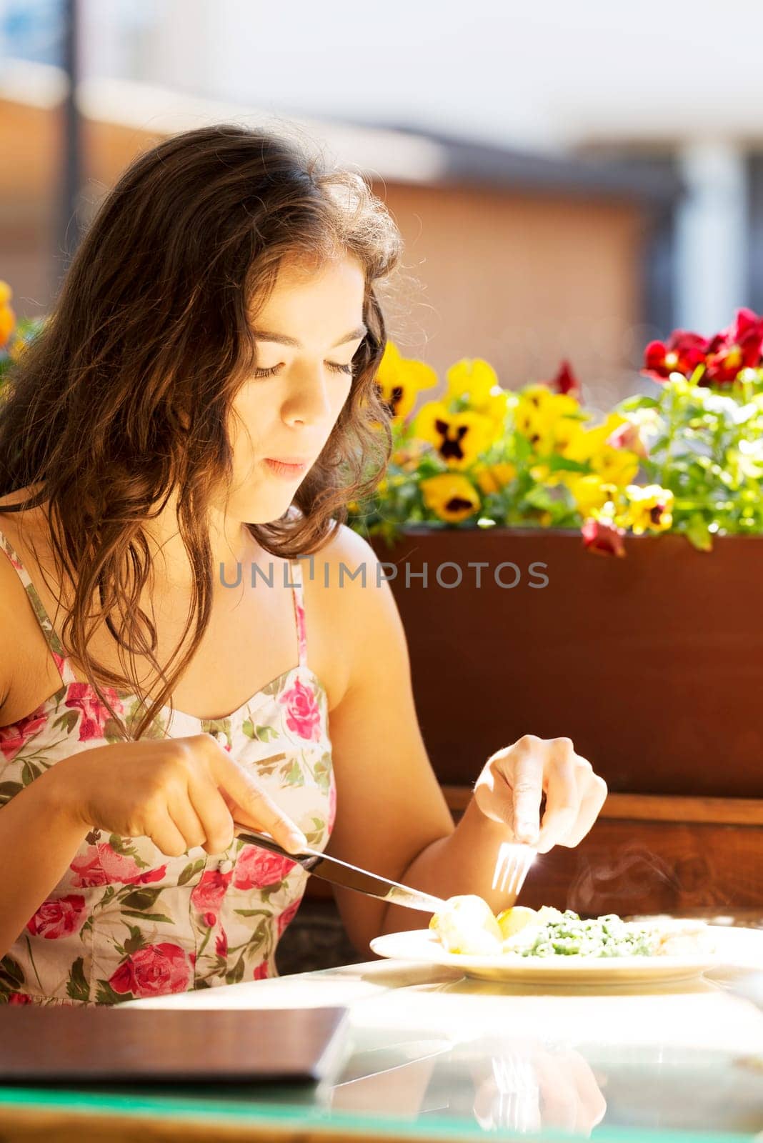 young summer woman eating dinner in restaurant.