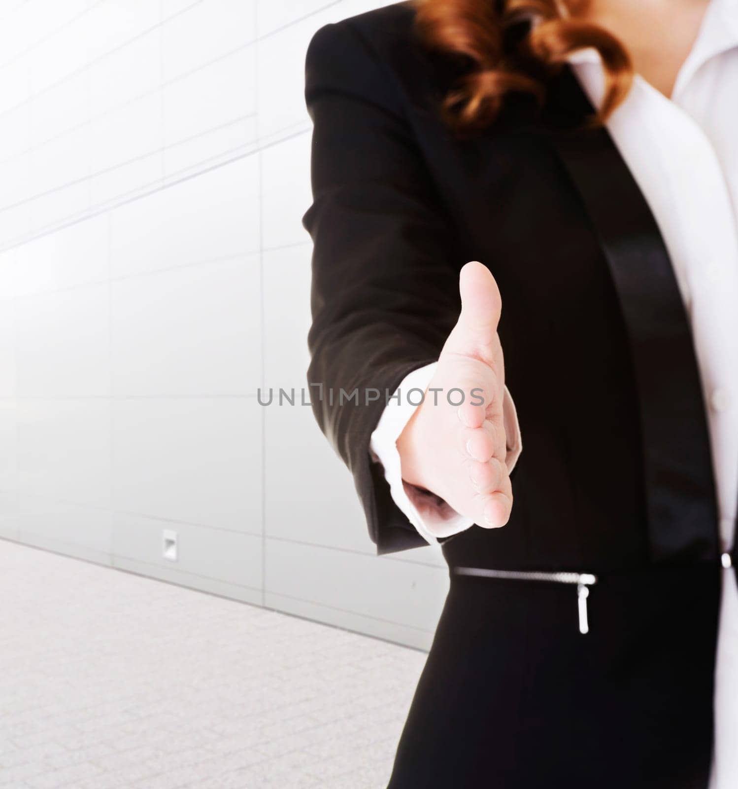 businesswoman about to shake hands.