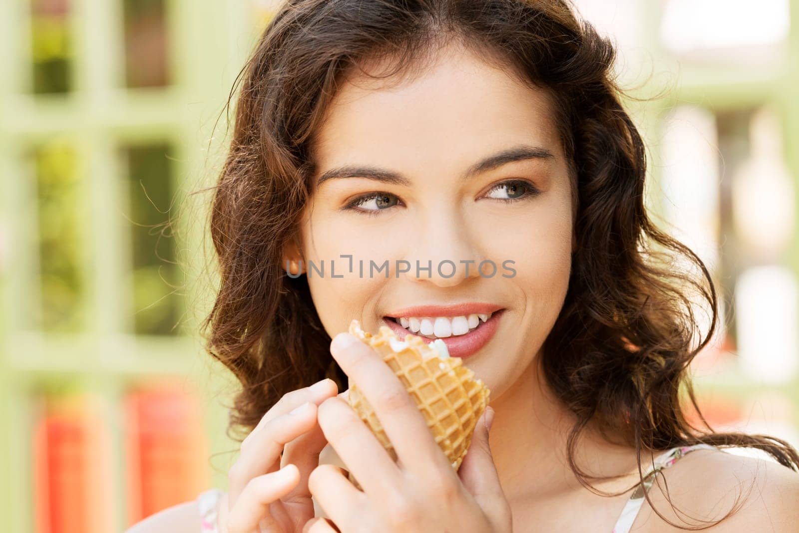 portrait of young happy woman eating ice-cream,outdoor