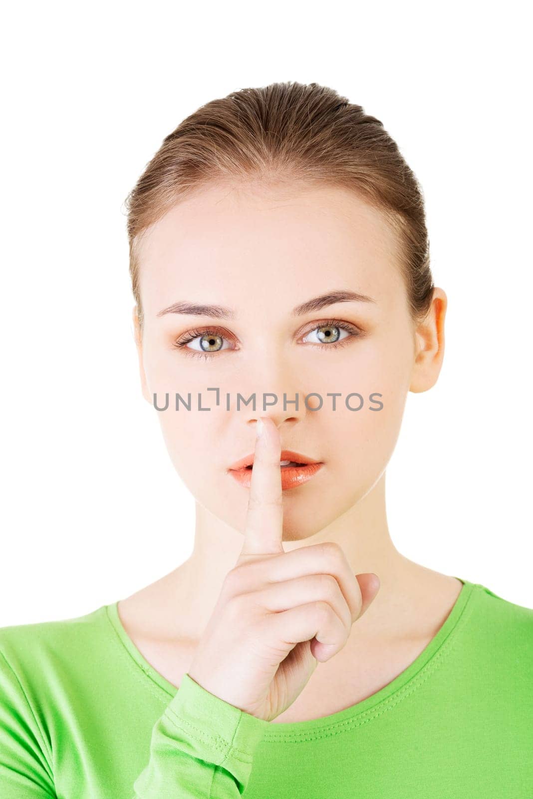 hush be quiet woman isolated. teen girl with finger on her lips.