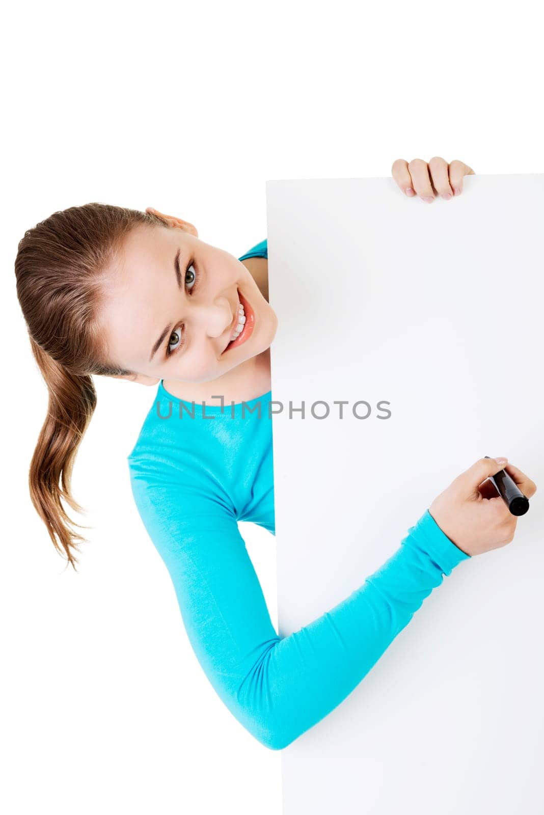 happy beautiful woman writing with a pen on blank board. student or businesswoman.