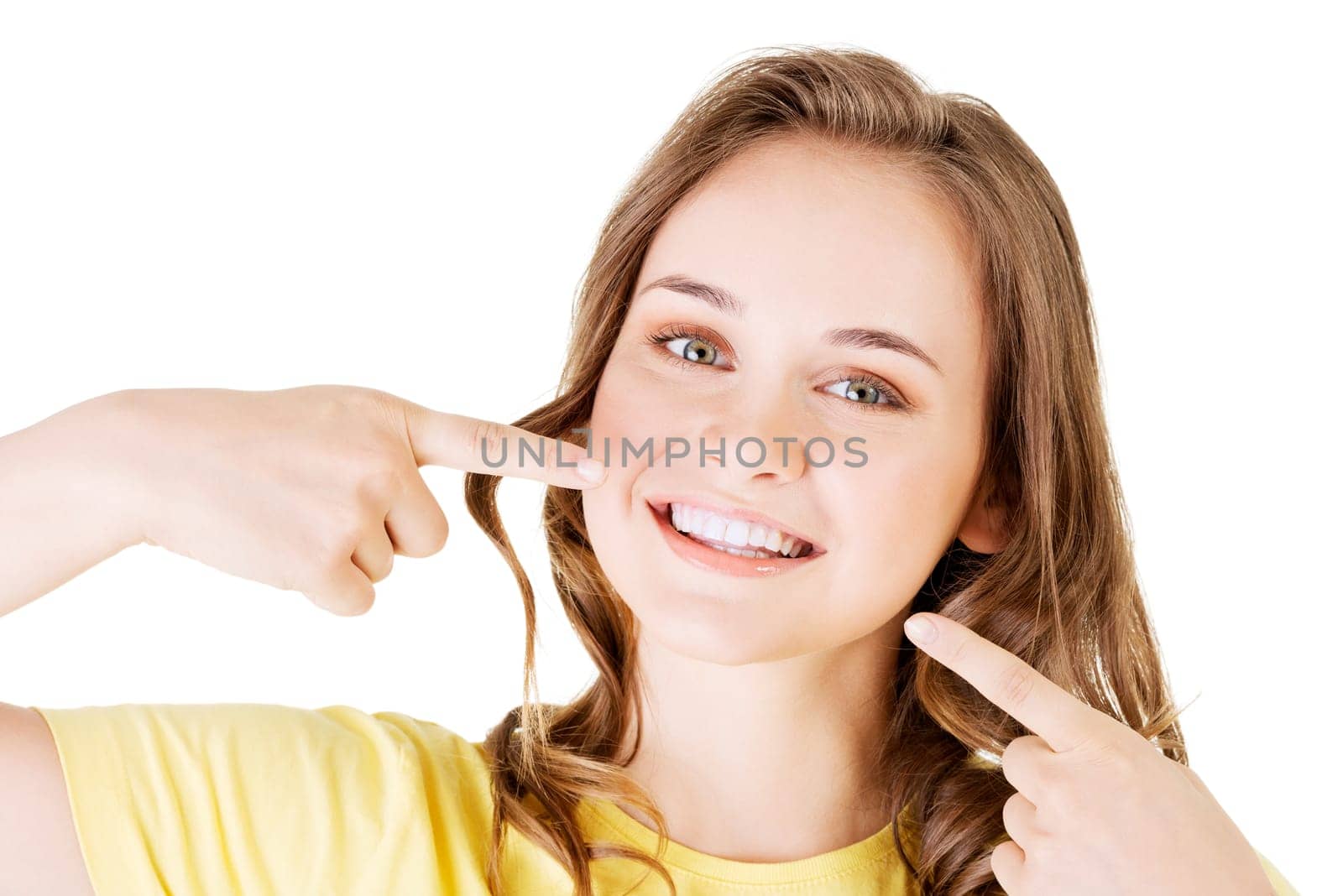 teen girl pointing on her perfect teeth,isolated on white