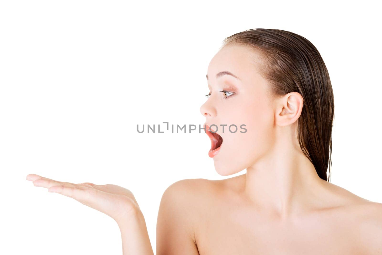 attractive woman with clean skin showing copy space on her palm