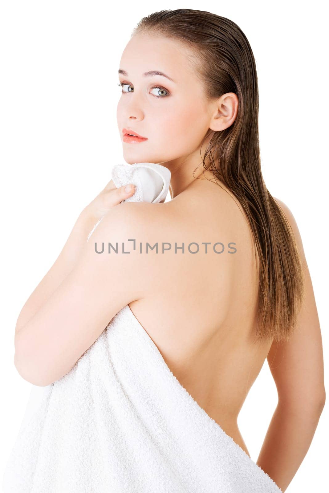 Young beautiful nude woman with towel,isolated on white