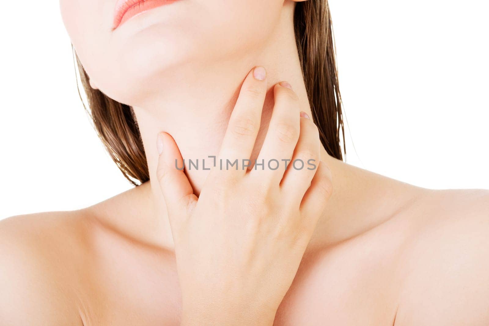 Beautiful sensual young woman touching her neck,isolated on white