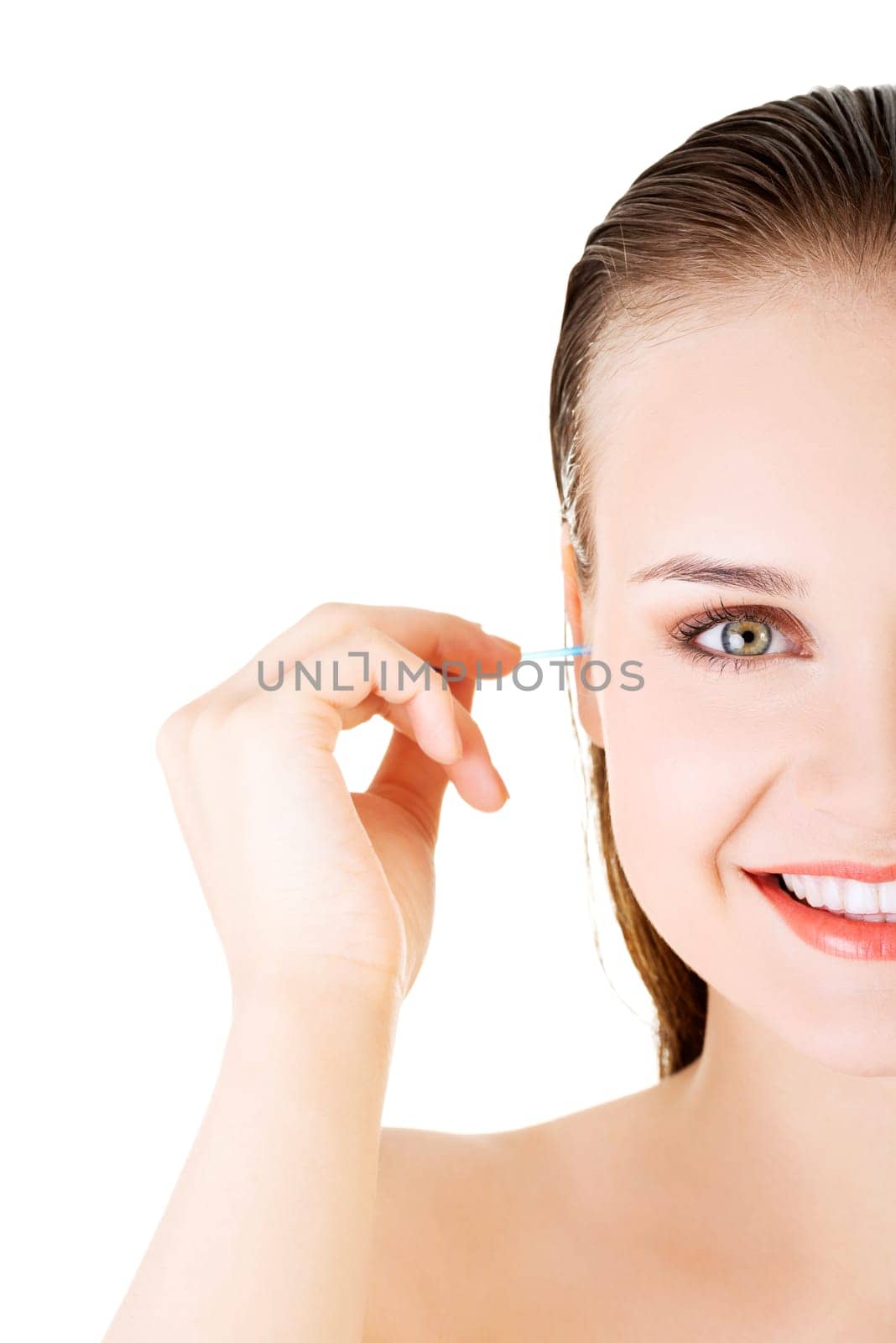 woman face closeup while cleaning up an ear with a swab,over white.