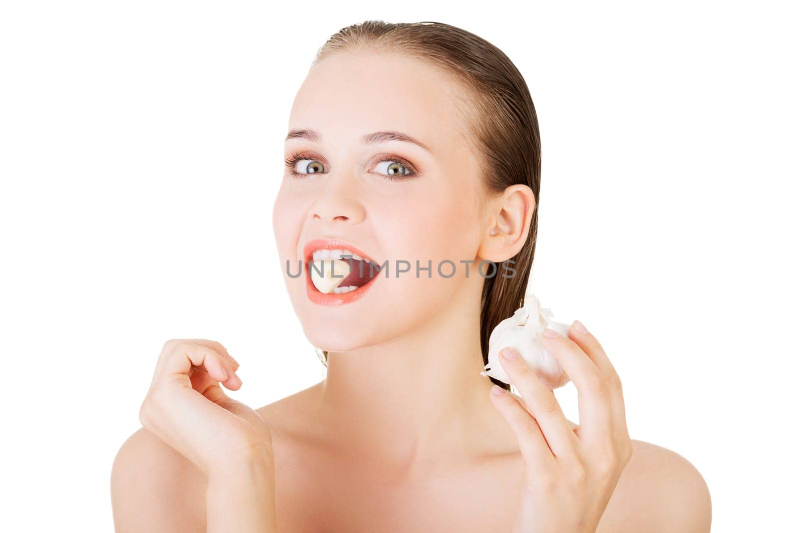 Young beautiful woman eating garlic. Healthy eating concept. Natural antibiotic that fight infection