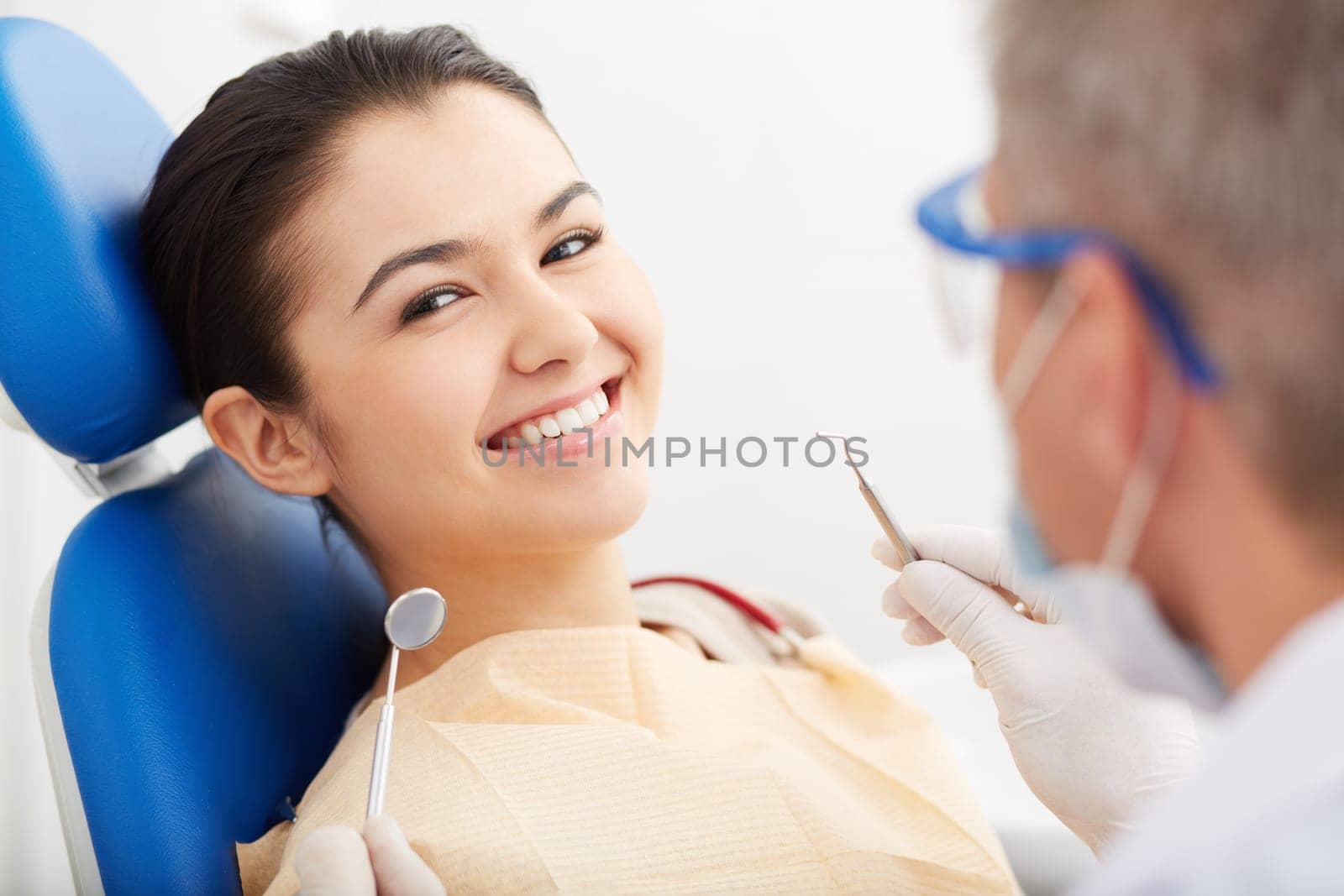 Image of smiling patient looking at camera at the dentist’s