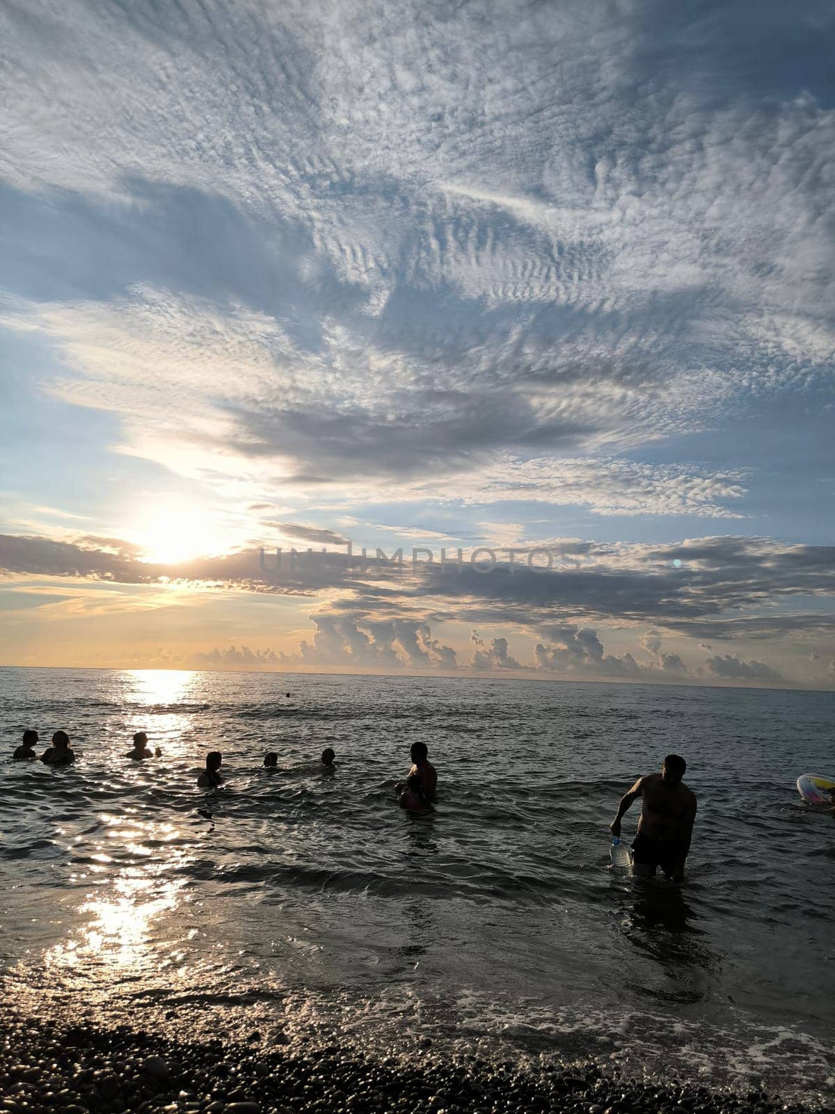 Sea water sunset sky landscape background blue nature orange light wallpaper evening people clouds . High quality photo