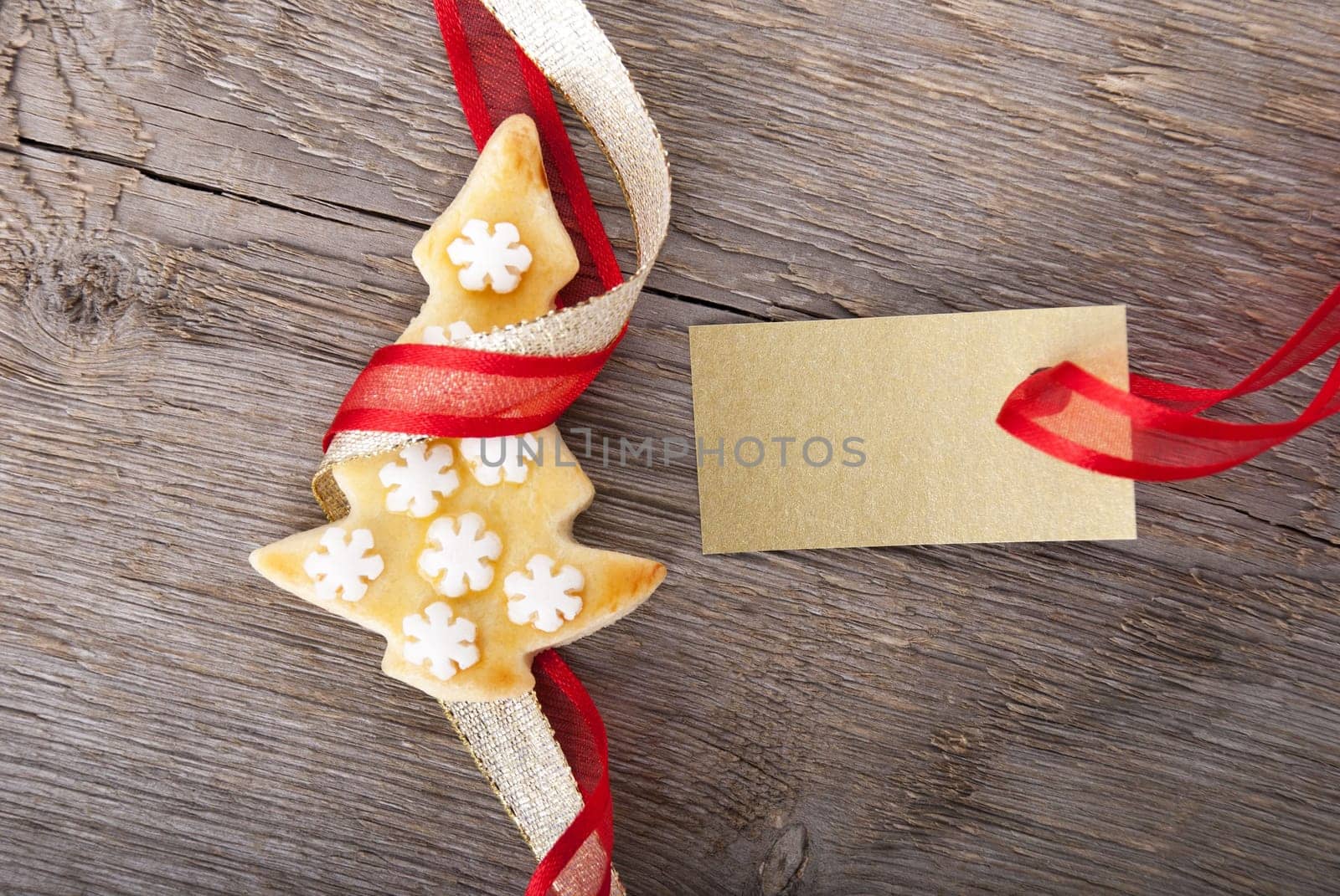 a golden tag with copy space and a christmas cookie as christmas background