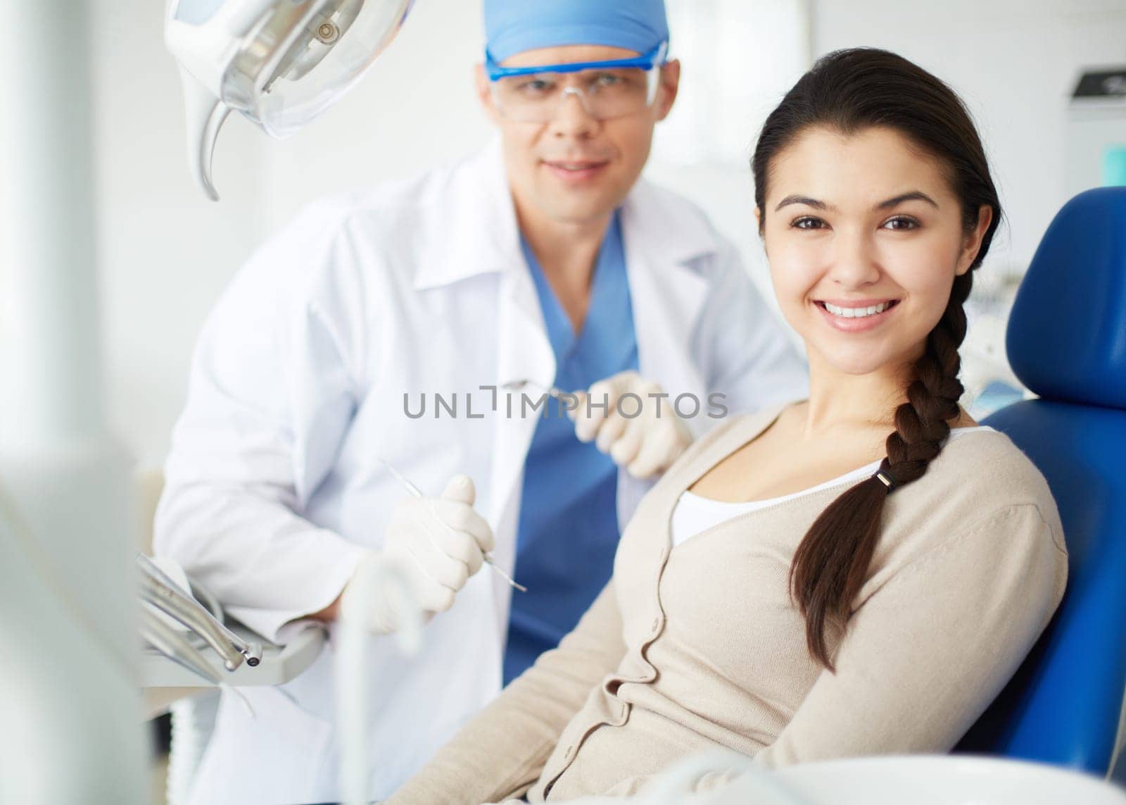 Happy girl looking at camera with toothy smile at the dentist’s