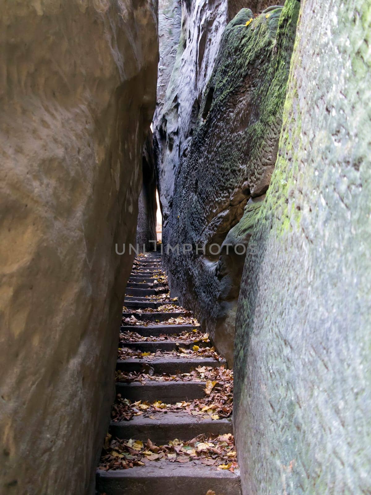 Narrow Parh - Mousehole - in rocks city in Bohemian Paradise..Bohemian Paradise is the Natural Protected Area. It was declared in 1955 was the first nature reserve in the Czech Republic. This part of land is popular thanks to a beautiful and varied countryside. There are a lot of places which should be seen - many natural beauties, castles, chateaus, ruins, museums, and other sights.