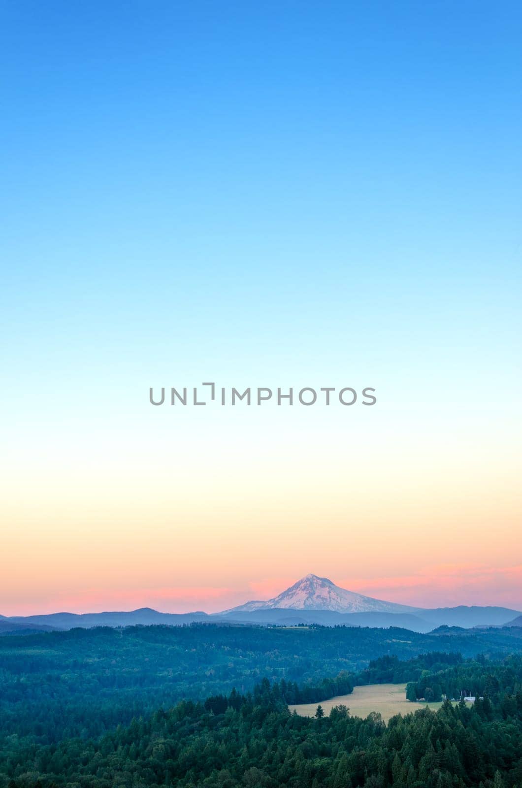 A vertical shot of Mount Hood at sunset with a lot of copy space