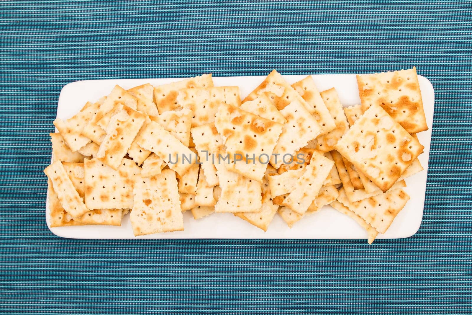 Lots of salted crackers, ones broken.