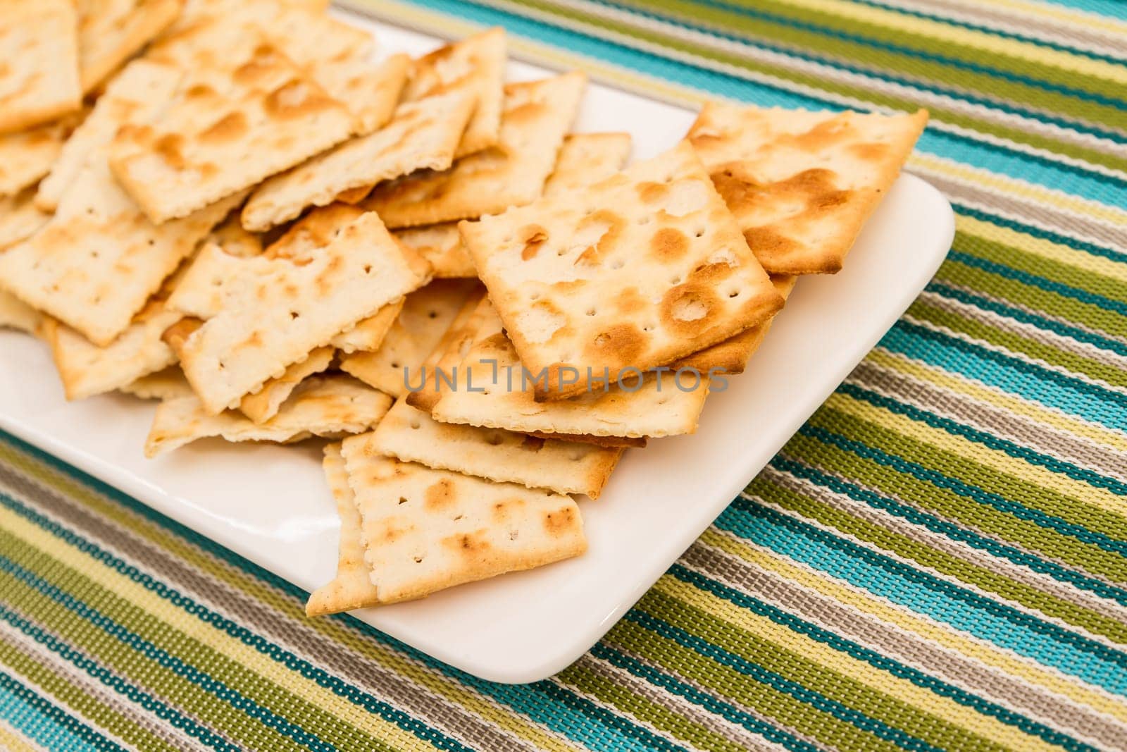 Lots of salted crackers, ones broken.