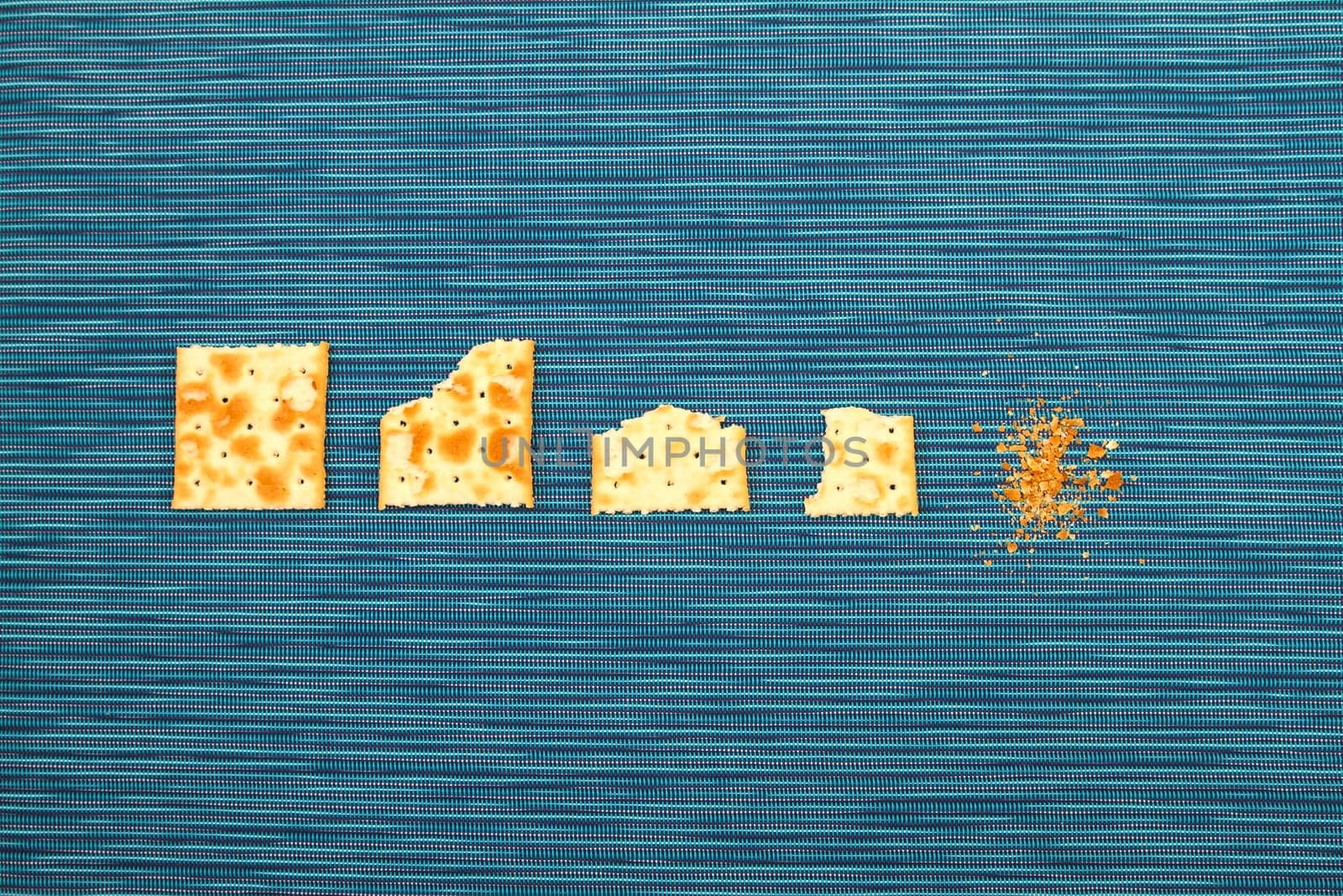 Salted crackers bitten process, background