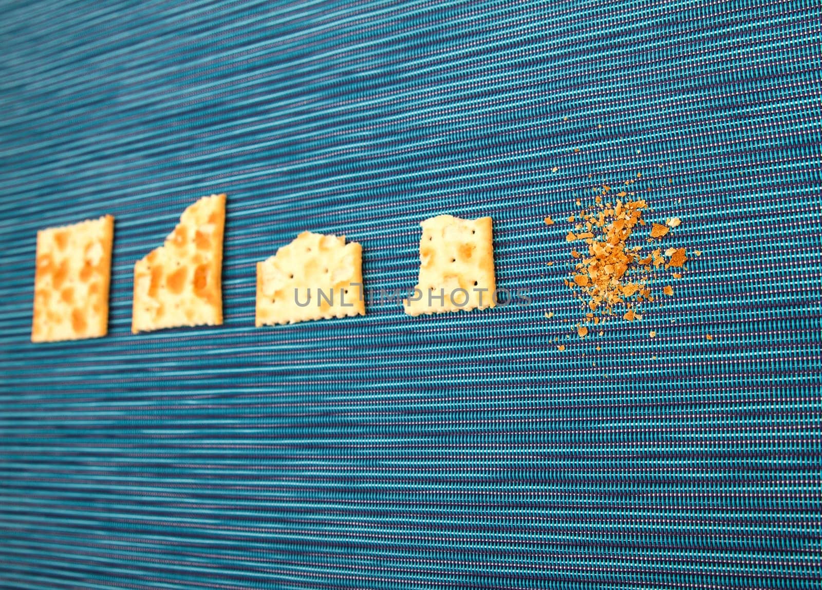 Salted crackers bitten process, background