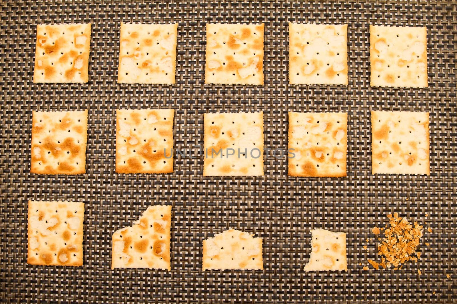 Salted crackers bitten process, background