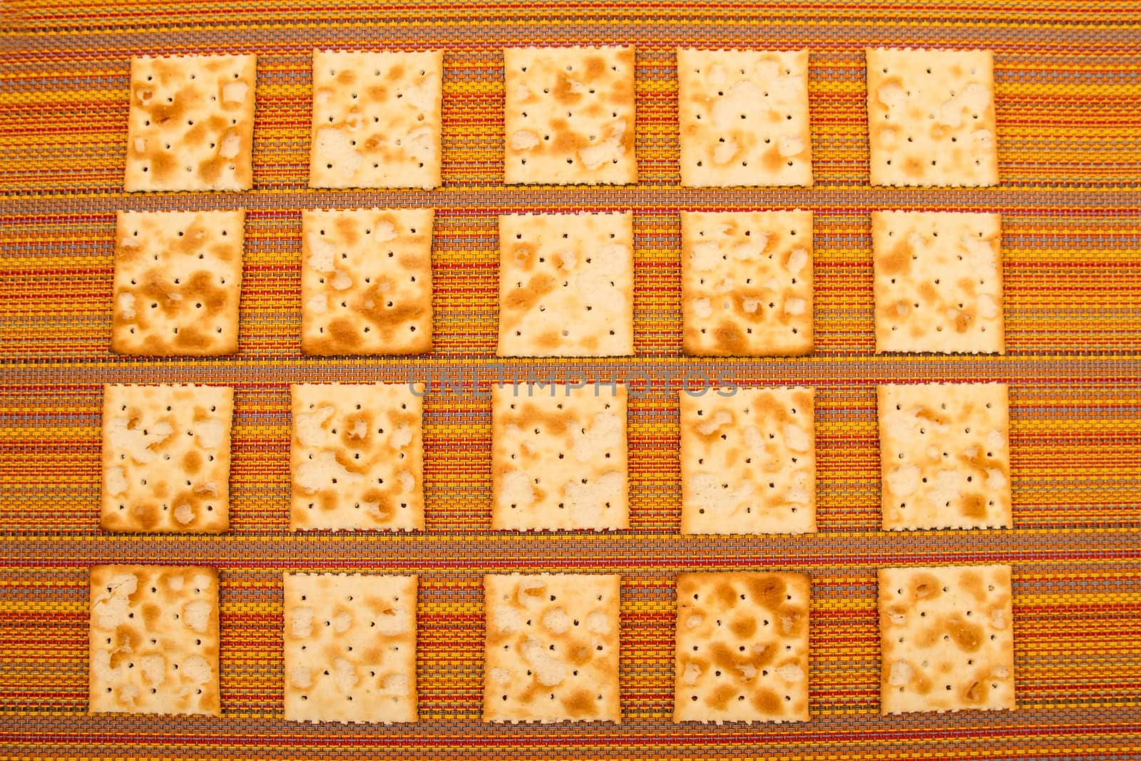 Lots of salted crackers, background.