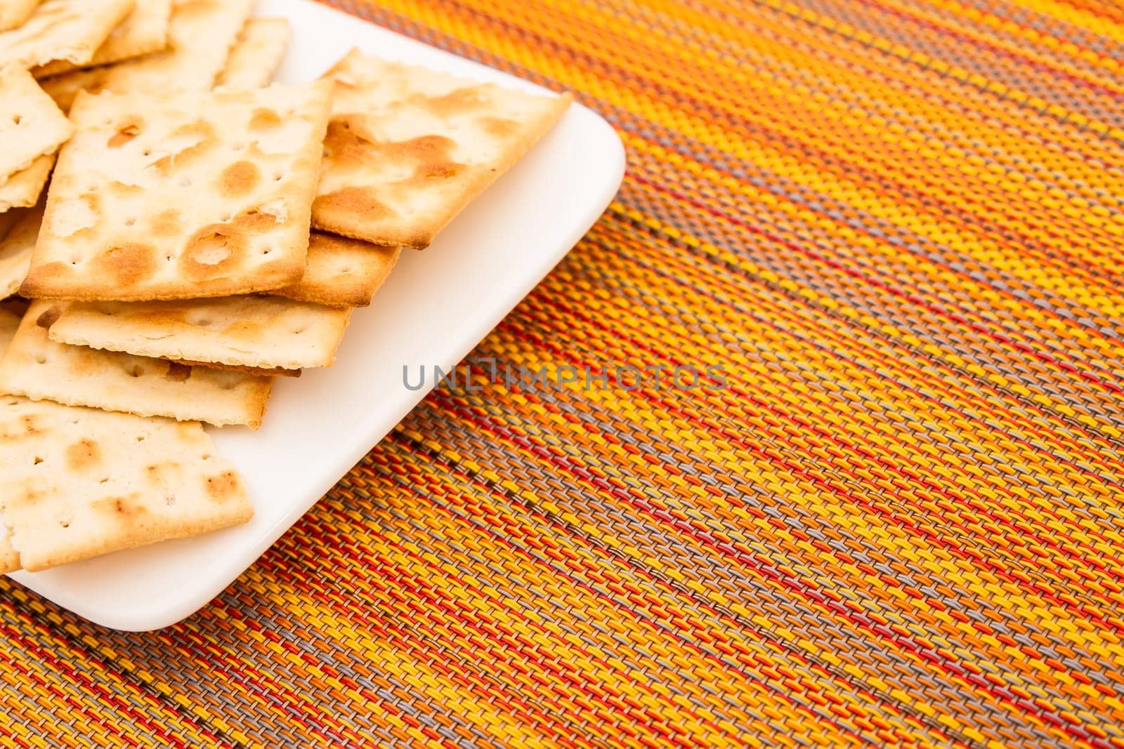 Lots of salted crackers, ones broken.