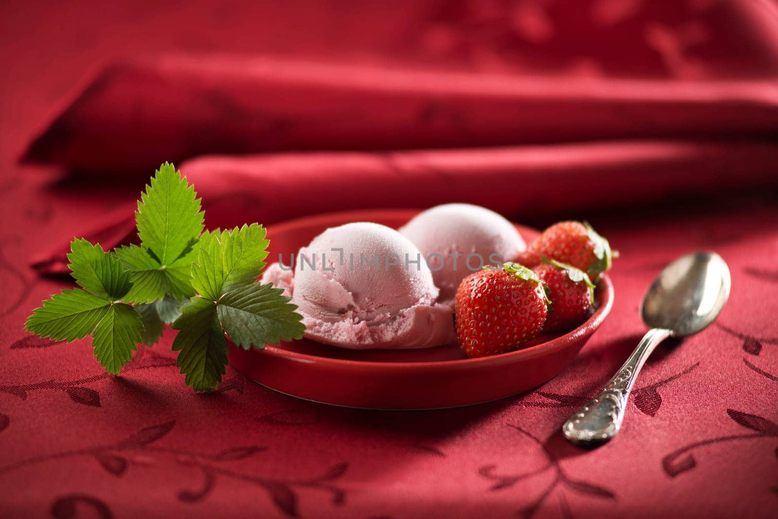 Strawberry ice cream on red background close up