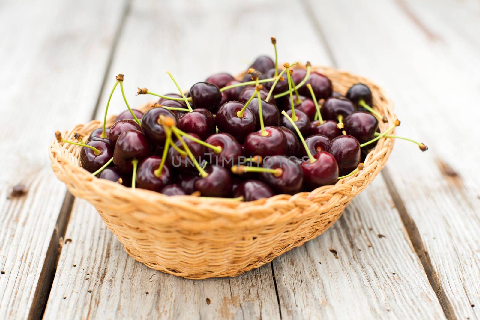 Ripe red cherries in a basket close up
