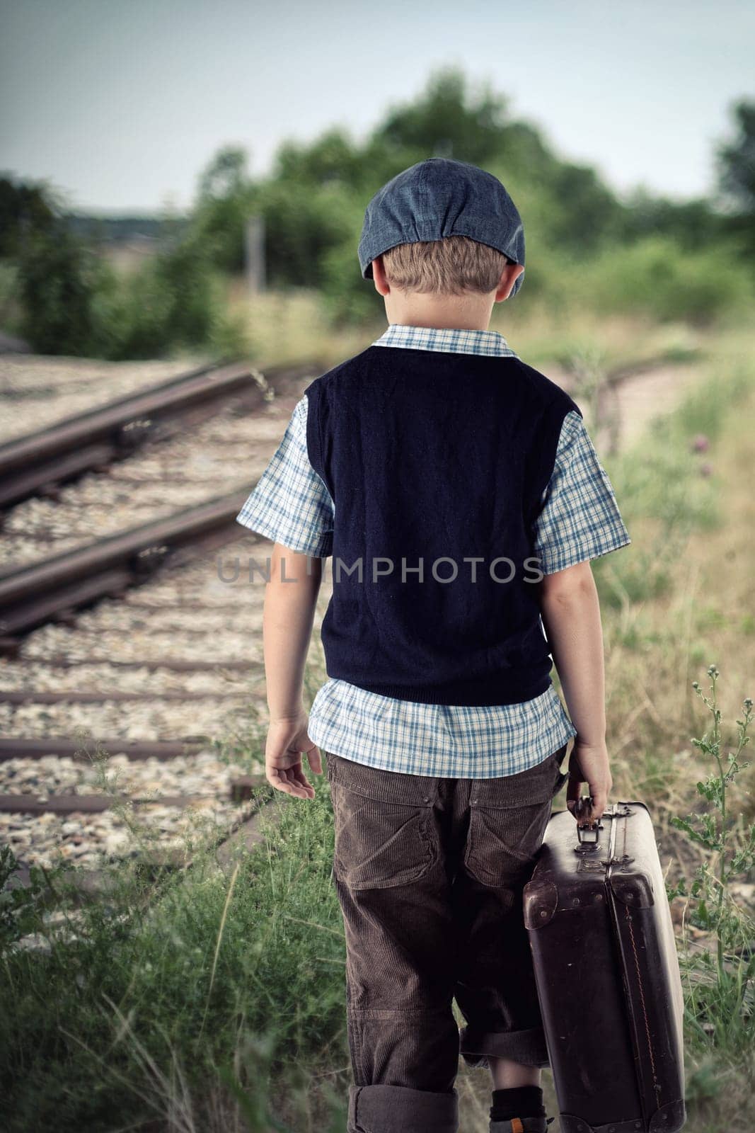 Boy with suitcase at the train station