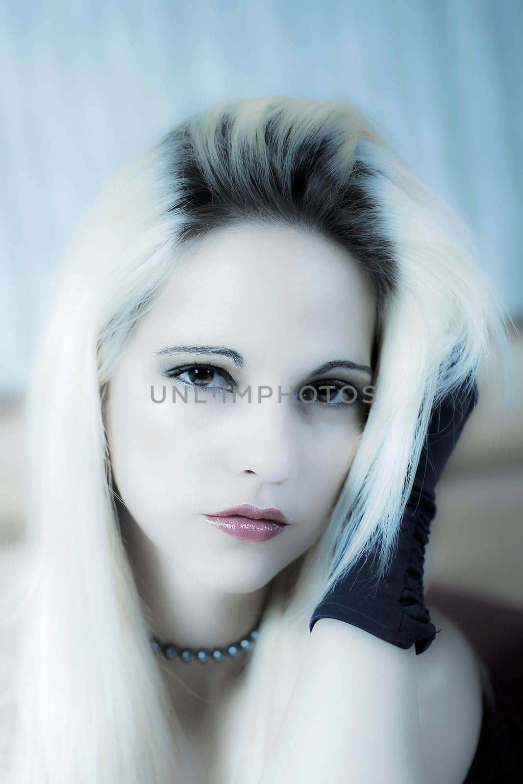sexy blond woman posing with a cool blue hue