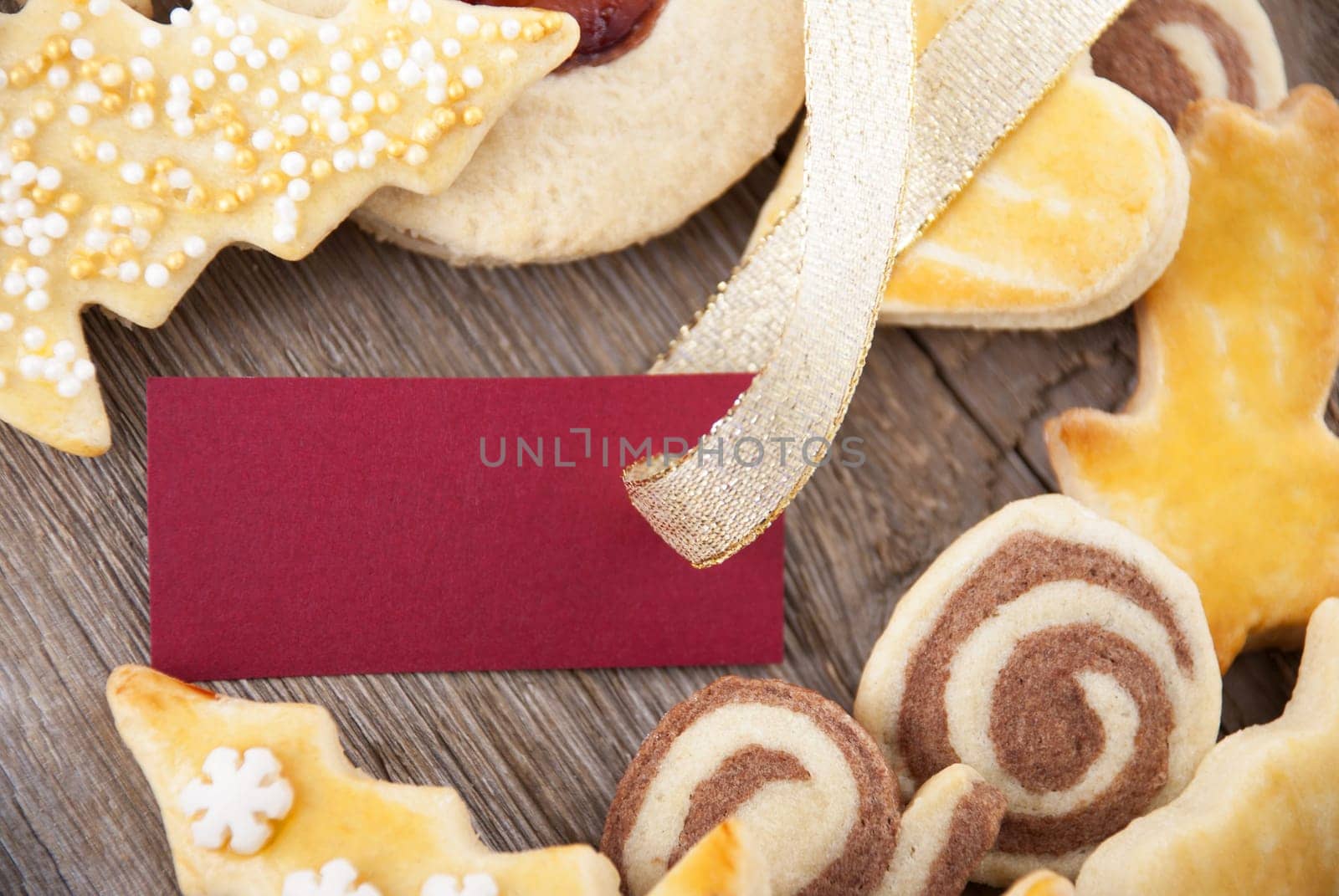 a background with christmas cookies and red label with copy space