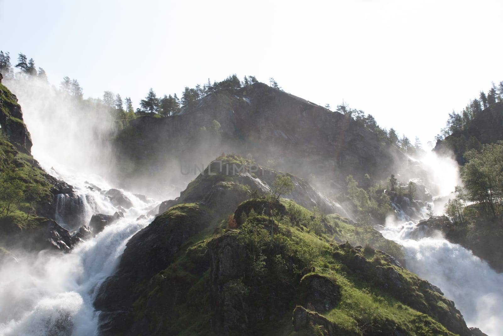 two huge waterfalls with trees around it